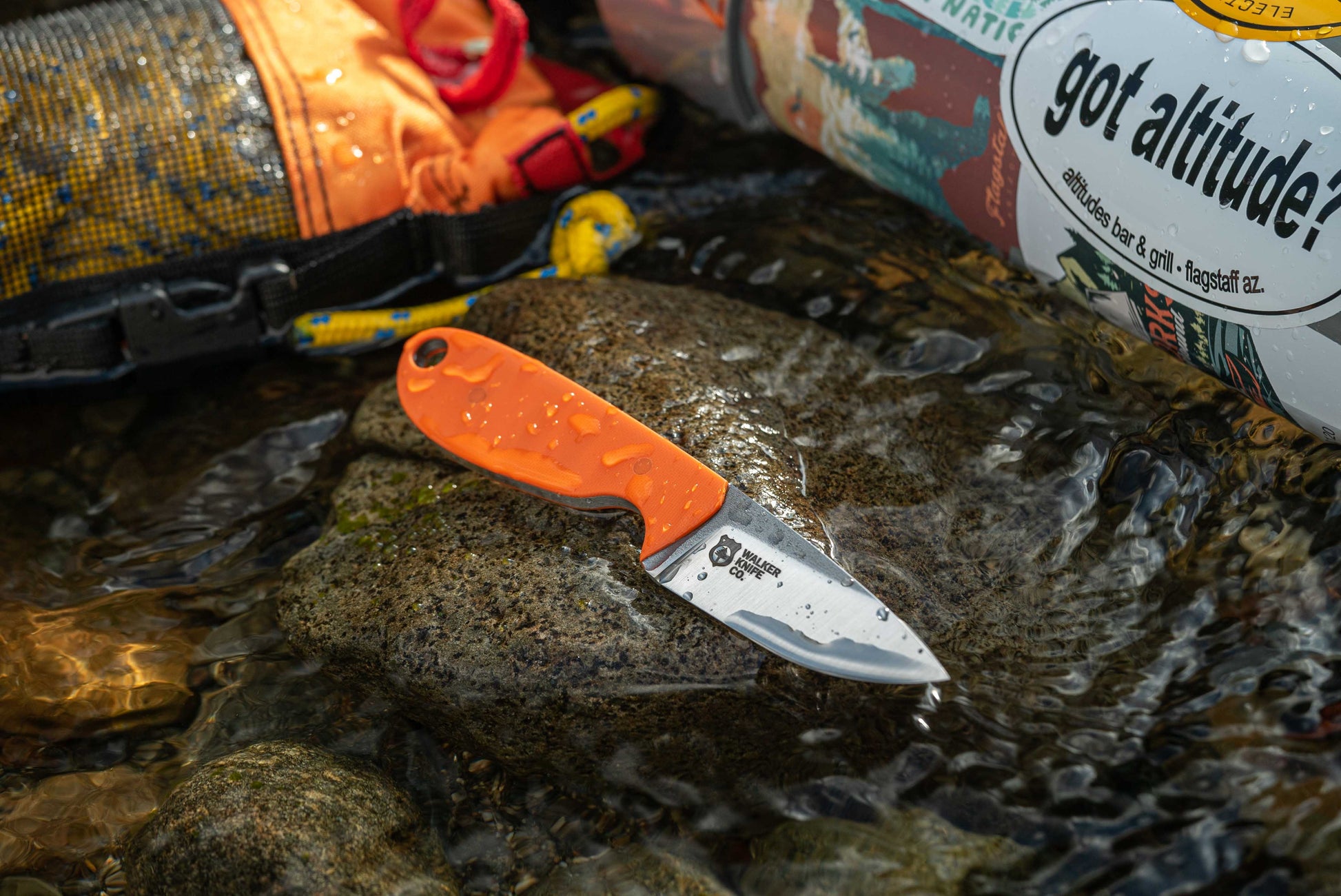 440C stainless steel river knife depicted in the water with river gear