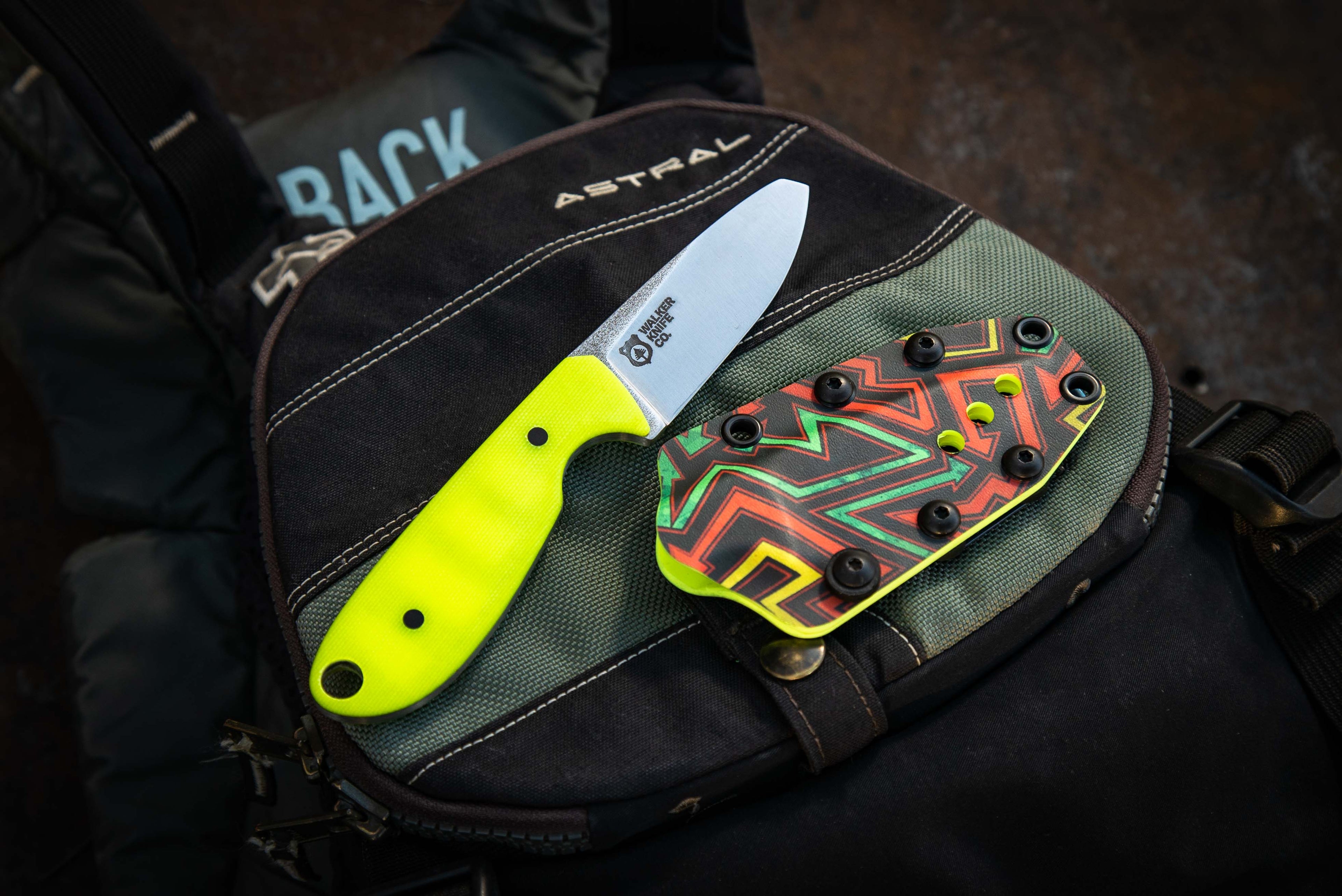 A blunt tip river rescue knife sitting on an Astral PFD